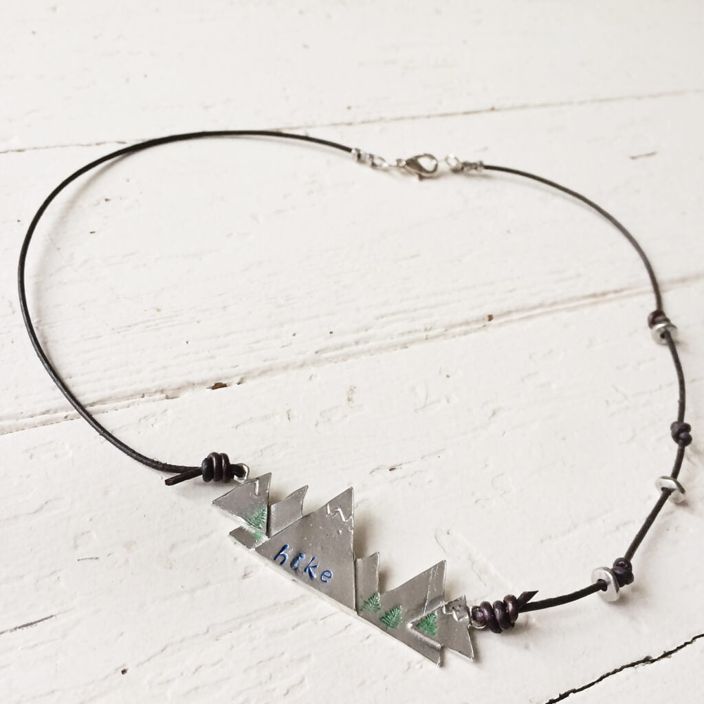 hike hand stamped mountain pewter and leather pendant necklace