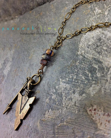 tribal arrowhead and arrow long brass necklace